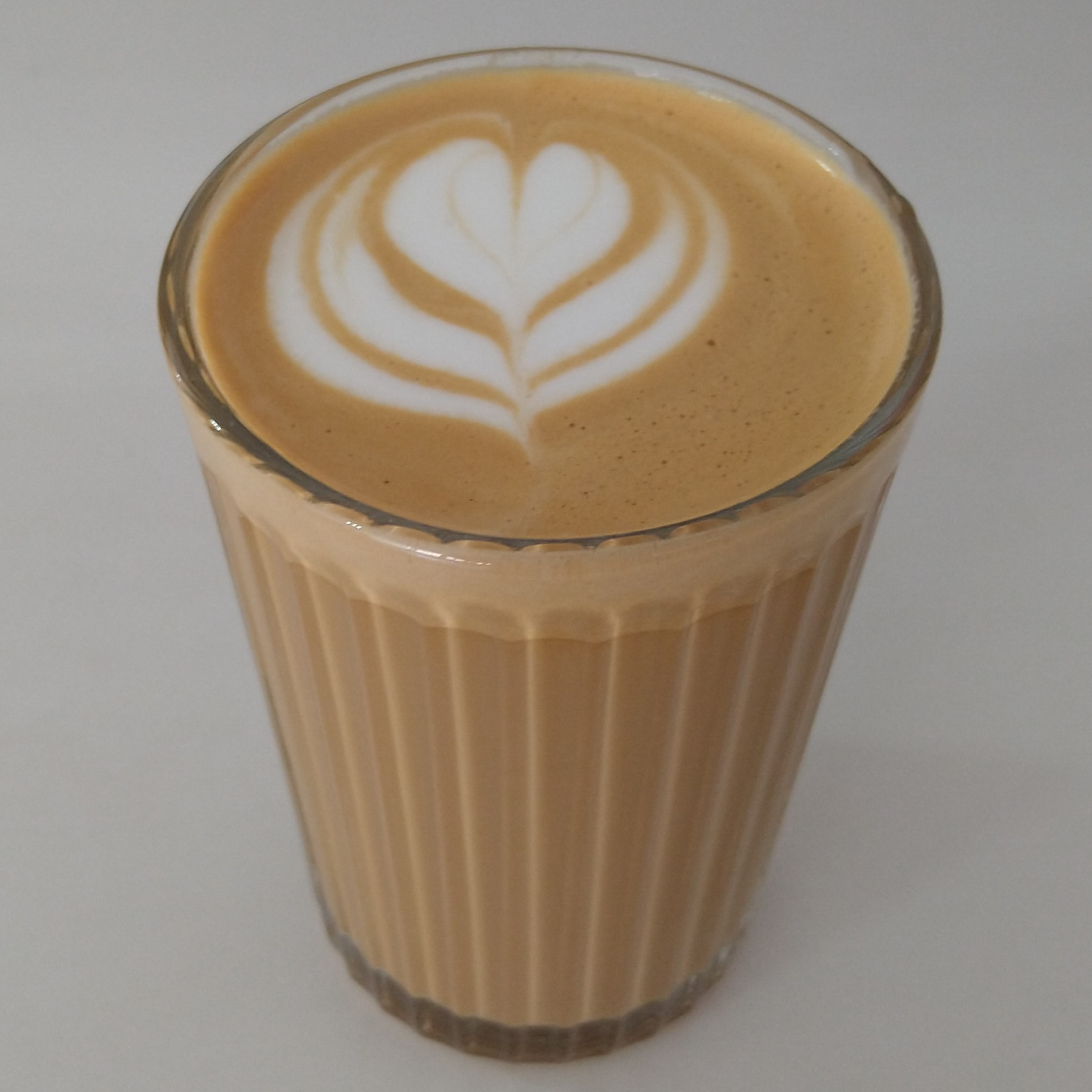 A lovely cortado, made with the Year One Anniverary Blend and served in a ribbed glass at Time & Tide Coffee.