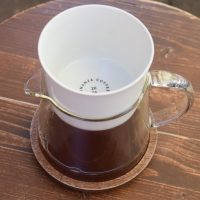 One of the three filter coffees in the filter tasting flight at the Bonanza Coffee roastery in Kreuzberg, served in a glass carafe with the cup placed on top as a lid.