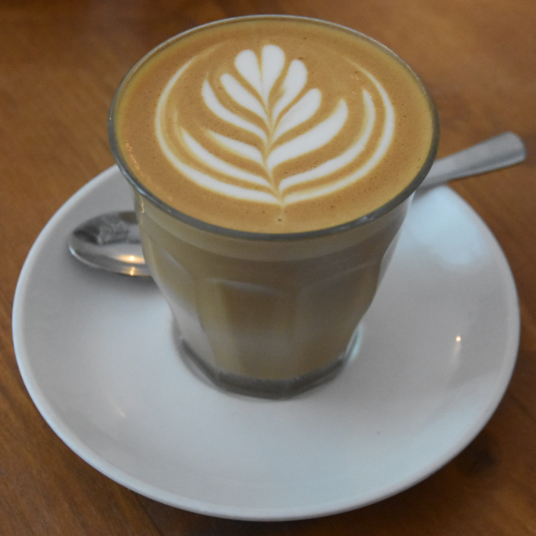 A lovely flat white, made with The Coffee Gang's bespoke house blend, and served in a glass at the original coffee shop on Hohenstaufenring.