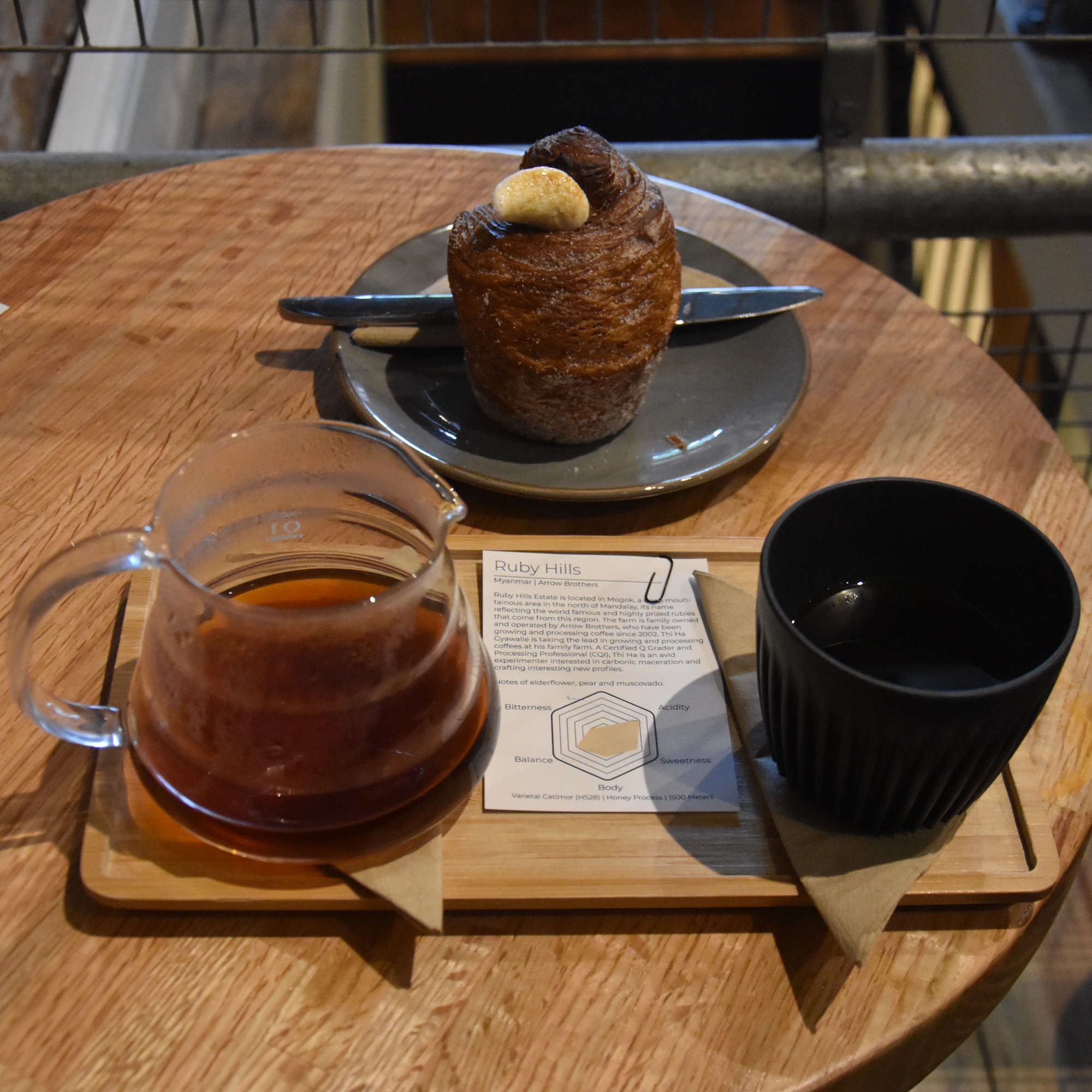 My coffee, the Ruby Hills, a honey-processed coffee grown by the Arrow Brothers in Myanmar, imported by Indochina Coffee and prepared using the V60. Served with a HuskeeCup and information card, I also had a cruffin which is in the background.