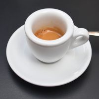 An espresso in a classic, thick-walled white cup, made with the lightly-roasted, naturally-processed Ethiopia Bombe G1.