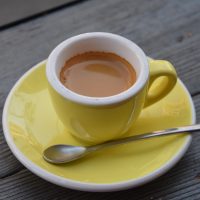 A classic espresso, made with Saint Frank Coffee's Little Brother blend and served at Scullery in San Francisco in a classic, bright yelllow cup.