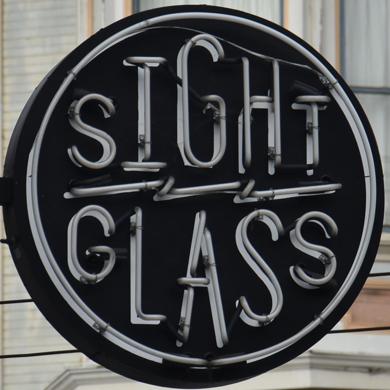 The circular Sightglass logo, with the word "Sight" on top, "Glass" at the bottom and a horitonal lightning bolt separating the two.