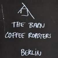 Detail from the A-board outside The Barn in the Sony Center, Berlin (in chalk, the wods "The Barn Coffee Roasters, Berlin" along with The Barn's logo.