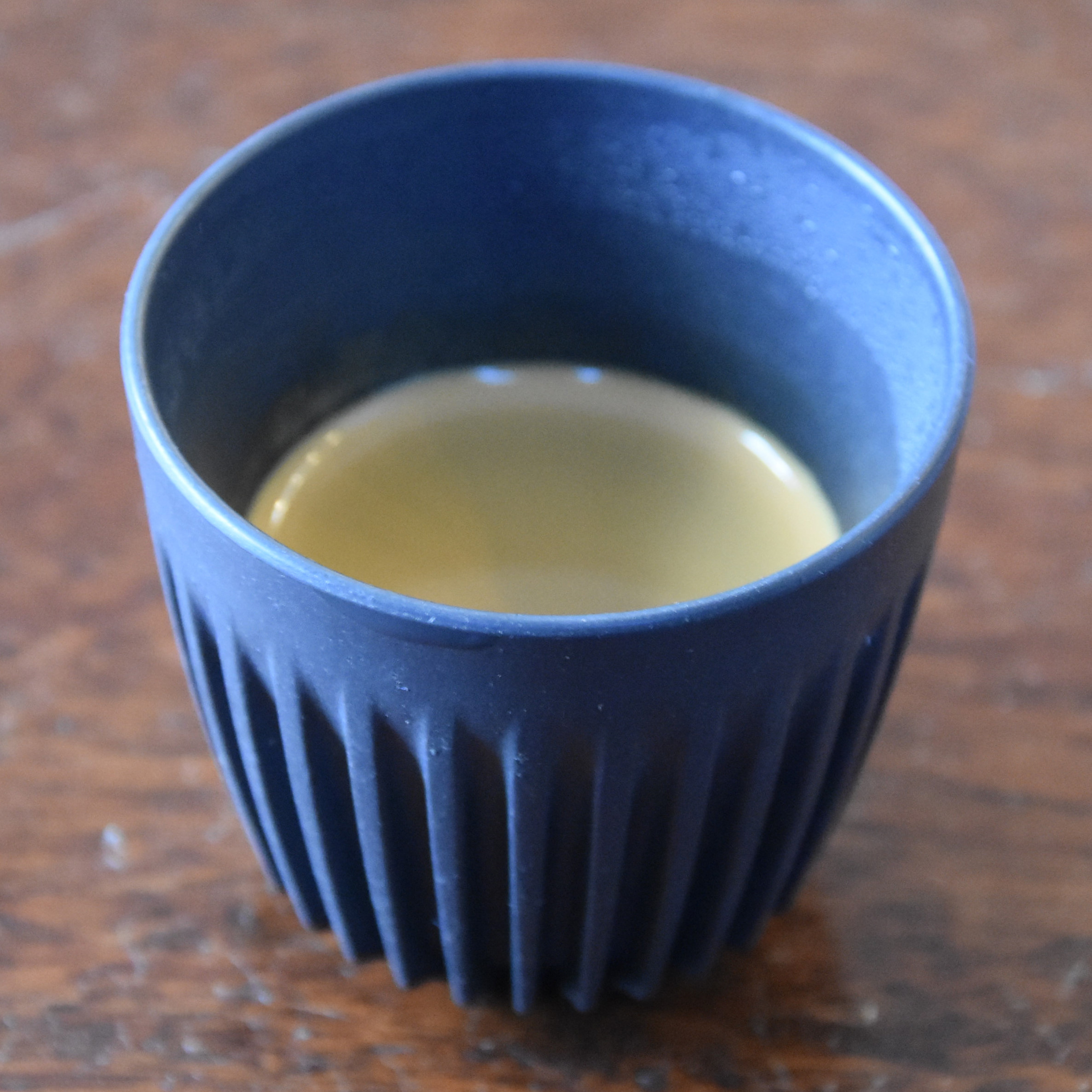 The distinctive HuskeeCup with its ribbed sides, but only 3oz in capacity, holding my espresso at Nomad Coffee Co.