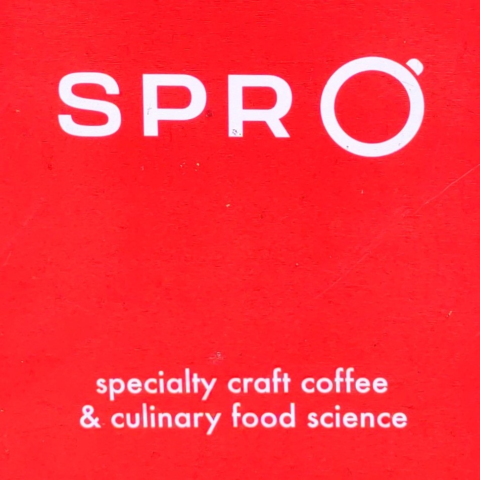 Detail from the A-board outside the Spro Coffee Lab trailer in Spark Social SF, with Spro in white on red and the words "specialty craft coffee & culinary food science" underneath