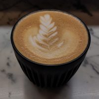 A flat white in my HuskeeCup, made with the Honey blend at Devoción in the Flat Iron District.