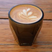 A fine cortado, served in a glass at Flat Track Coffee and made with the house blend.