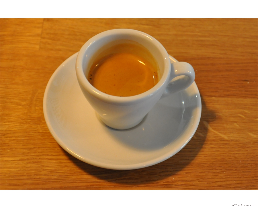 An espresso (not mine) in a classic white cup.