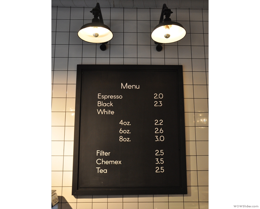 An amazingly concise coffee menu, hanging on the wall behind the counter.