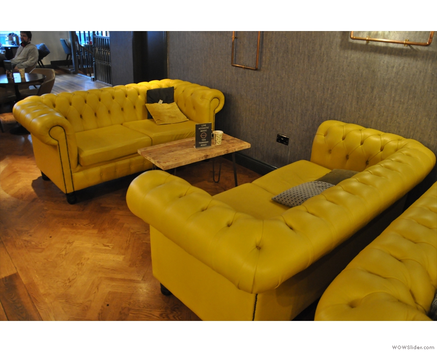 These large, comfy, yellow(!) sofas are on the left. There are two pairs of them...