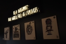There's an illuminated sign, plus some quirky artwork, on the wall above the bar.
