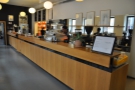 The counter is very long, with the coffee-making operation at the end nearest the door...