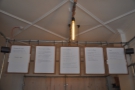 The menus hang up on clipboards above the counter.