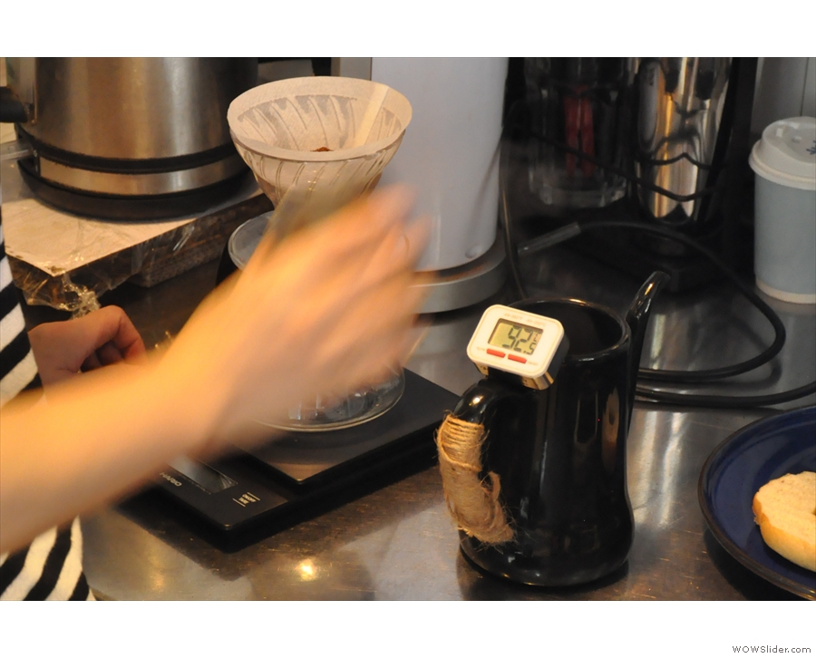 As the ground coffee is added to the V60, so the water's cooled to the correct temperature.