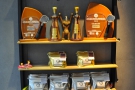 The shelf on the left-hand wall holds bags of coffee and displays various awards.