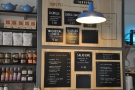 The food menu is chalked up on the wall to the left of the counter.