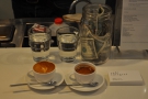 Another order, a macchiato and an espresso, plus two glasses of water, ready to go.
