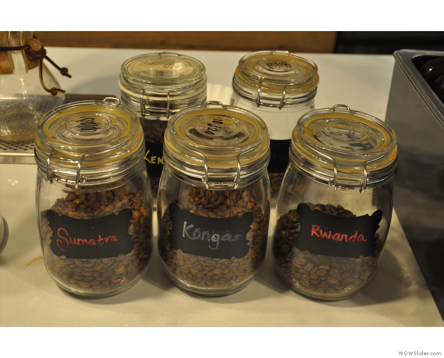 The beans on offer are displayed in glass jars next to the Seraphim.
