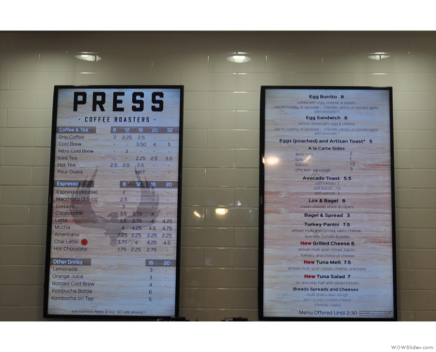 The menus are up on the wall behind the till...