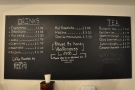 The menu is chalked up on the blackboard behind the counter...