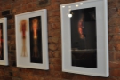 There are photos artfully hung on the plain brick wall...