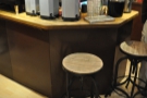 There's been more redistribution of the seating. These stools, which were by the counter...