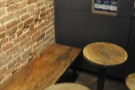 ... which runs the length of the wall. What look like they might be stools are in fact tables.