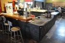 Looking back at the counter, with seating on the left and on the opposite side.