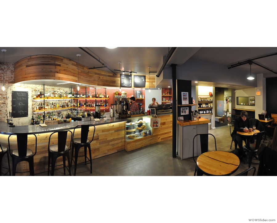 A panorama from just inside the door, showing the bar on the left, coffee at the back.
