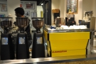 The bright yellow La Marzocco espresso machine has pride of place at the front of the counter.