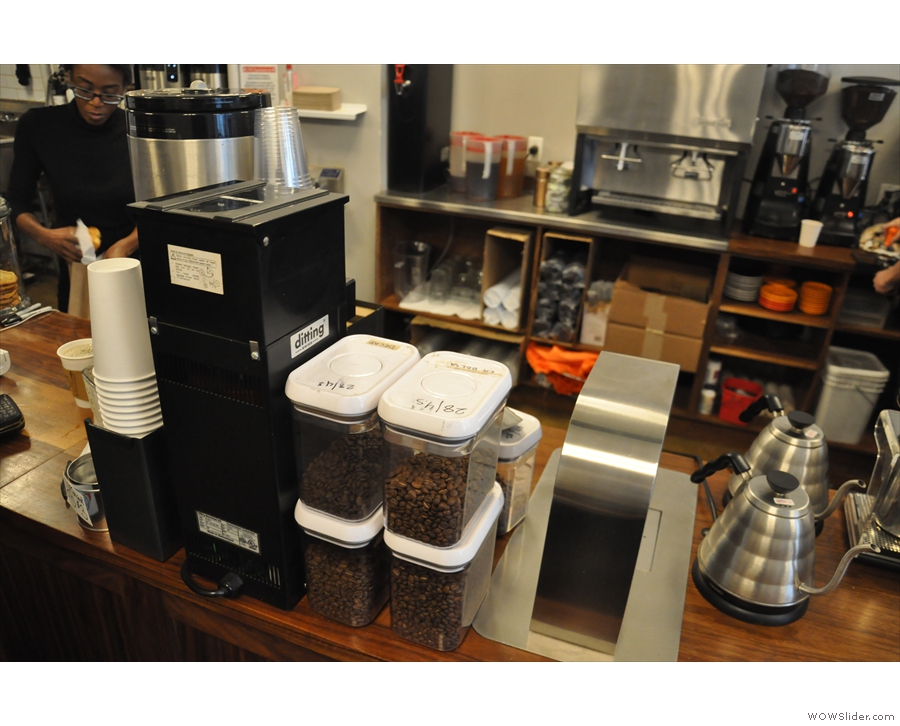 The various single-origins for the pour-over are in plastic bins on the counter top.