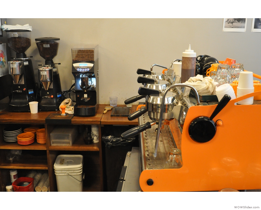 The Synesso espresso machine is in Café Grumpy colours, the grinders off to one side.