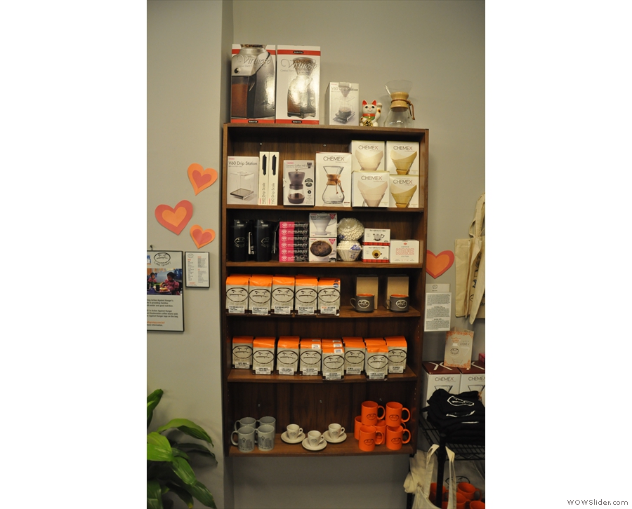 The retail shelves, with all sorts for sale, including merchandising, coffee kit...