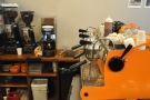 The Synesso espresso machine is in Café Grumpy colours, the grinders off to one side.