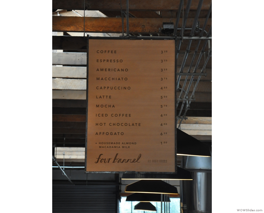 The main coffee menu hangs from the ceiling above the counter...