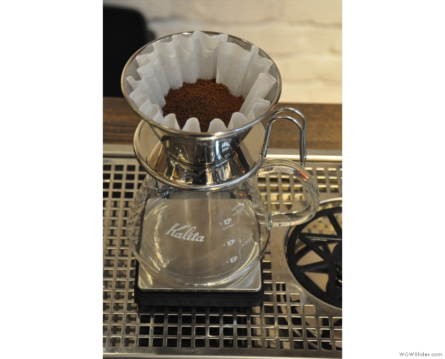 The ground coffee in filter paper, ready to go. [H]AND uses handmade Kalita Wave filters.