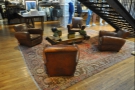 ... four sumptuous armchairs, clustered around a coffee table, seen here from [H]AND.