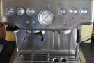 The main controls: power/grinder (left), espresso (right), with a central pressure gauge.
