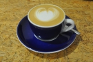 My decaf cappuccino, served in a classic blue cup with white trim.