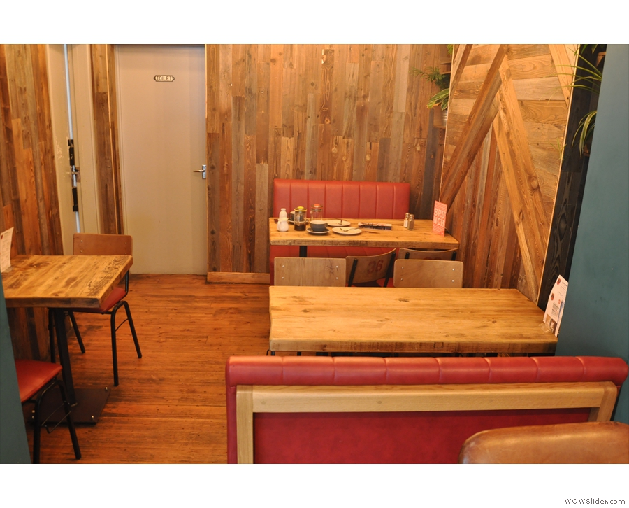 Beyond that, the space narrows into this alcove, with two four-person tables on the right...