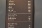 The coffee menu is also on the left-hand wall, just a little further back above the counter.