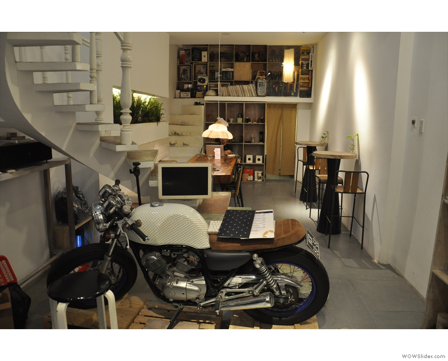 Beyond the counter is a motorcycle and a flight of stairs...