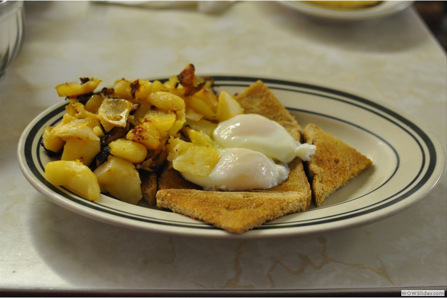 The breakfast of kings: two eggs, poached, wheat toast and home fries...