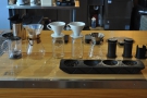 Between the two stands an array of filter options: Chemex, V60, Kalita Wave, Aeropress.