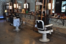 The barber's chairs line the right-hand wall, each with its own mirror.