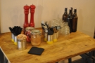 Condiments, cutlery and water, between the front and back seating areas.