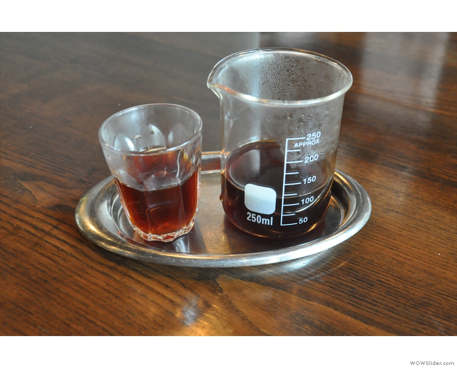 ... served in a small beaker with a glass on the side.