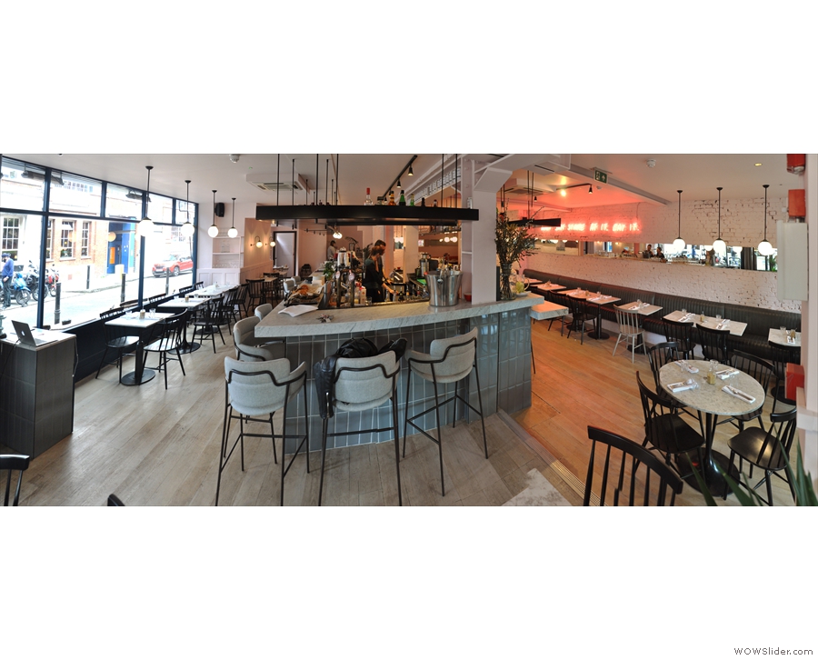 A panoramic view of Exmouth Market from the front, with seating down either side.