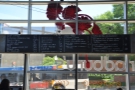 The menu is painted on a board on the window to the left of the counter...